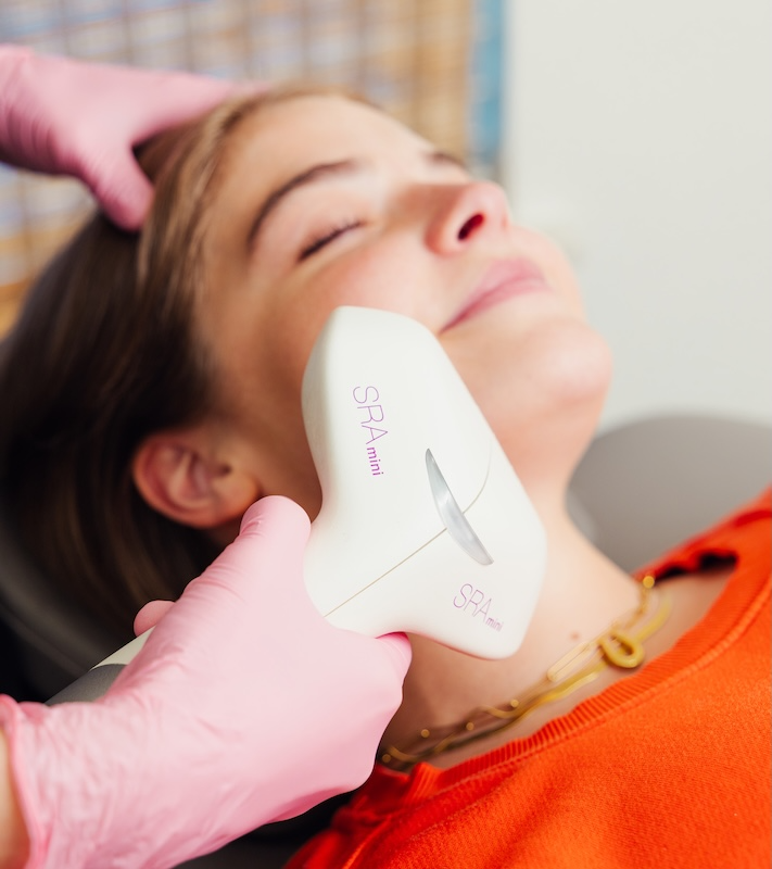 woman receiving facial treatment at glow houston