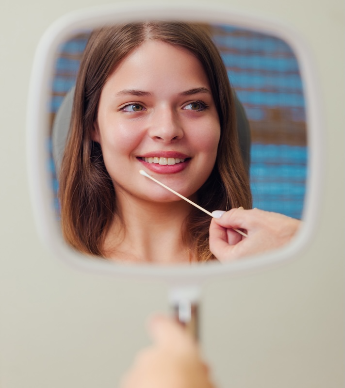 woman looking in mirror at glow houston